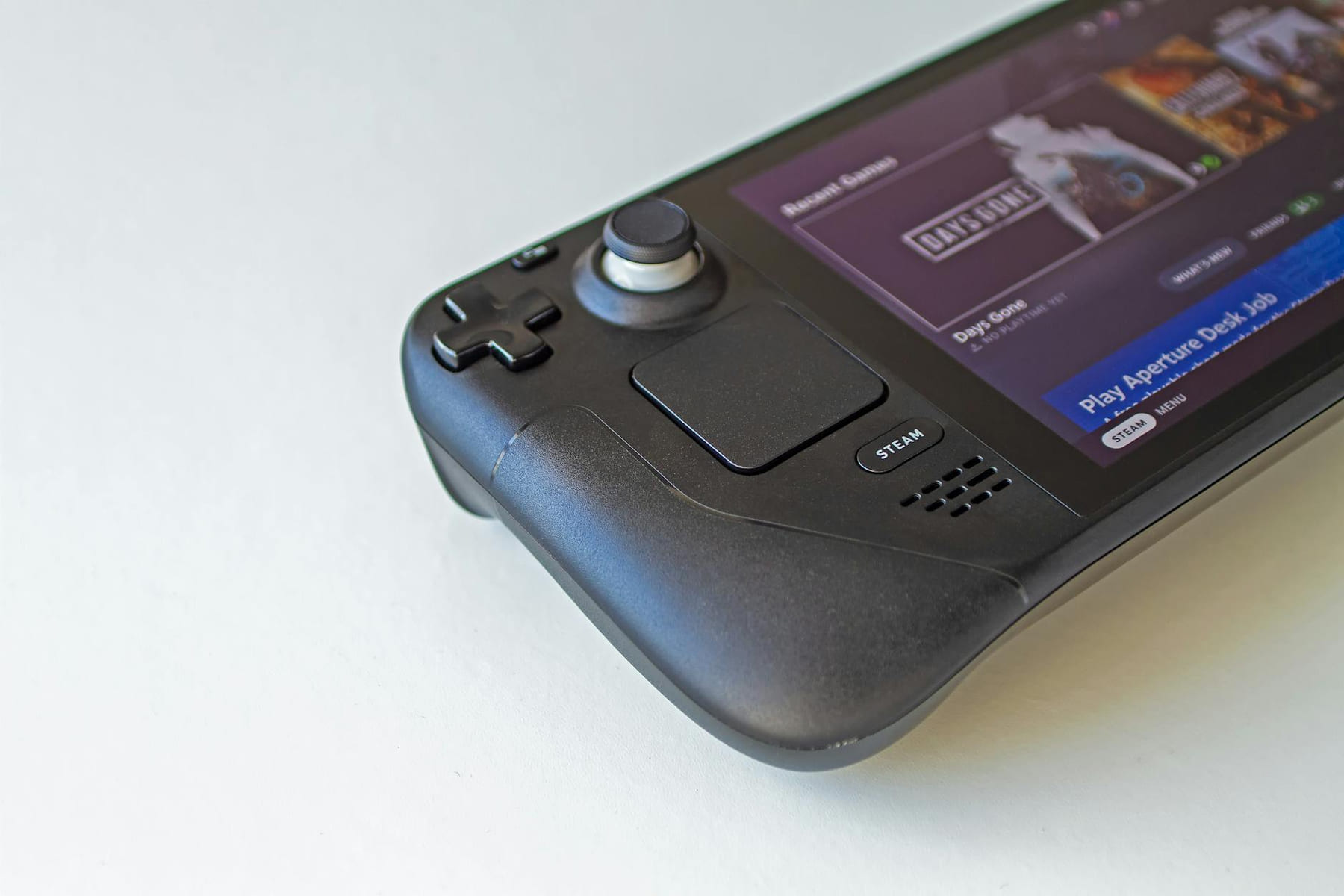 Detailed view of a handheld gaming console showcasing game selection on its screen. on The Loading Screen