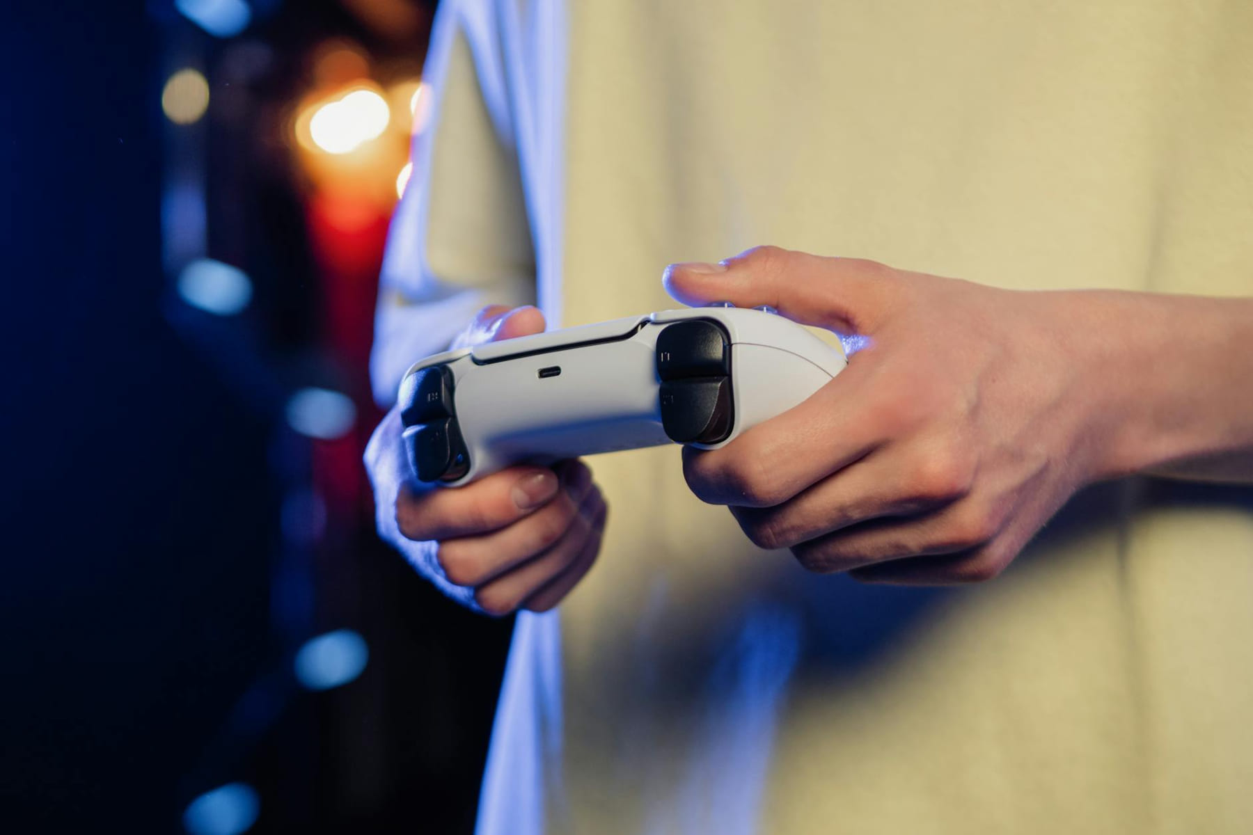 Hands gripping a game controller, displaying focus during an intense gaming session. on The Loading Screen