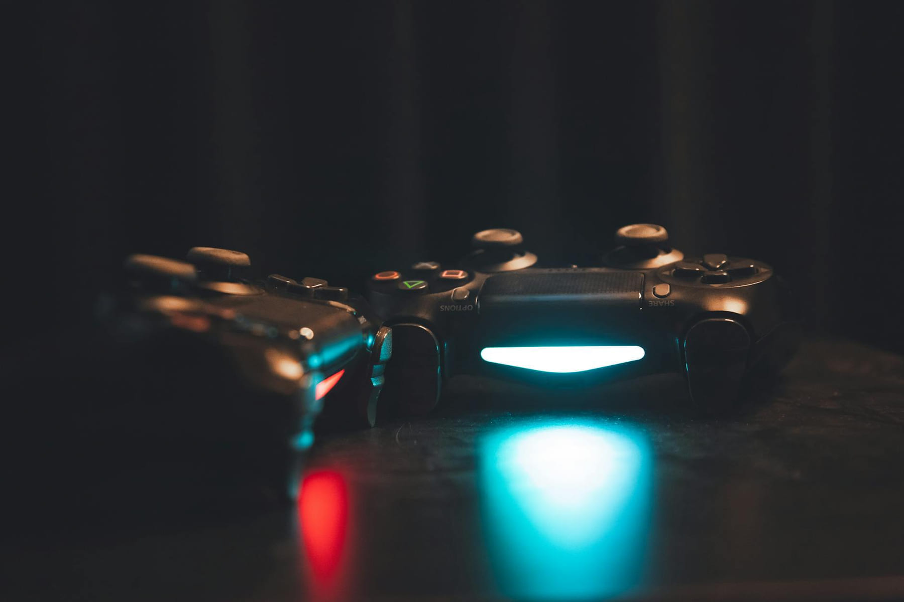 Close-up of glowing gaming controllers on a dark surface, creating a moody ambiance. on The Loading Screen