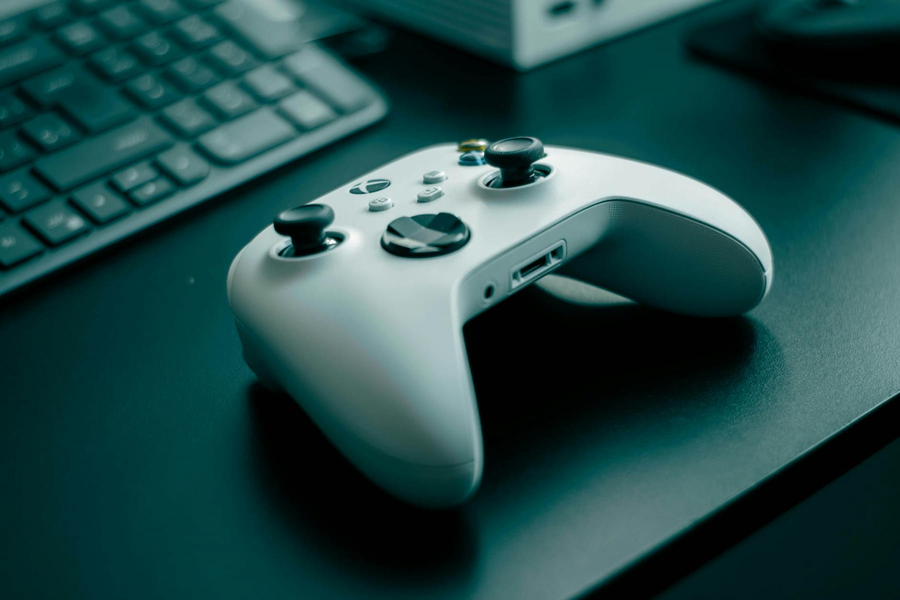 Close-up of a white game controller on a sleek desk, highlighting technology and gaming. on The Loading Screen