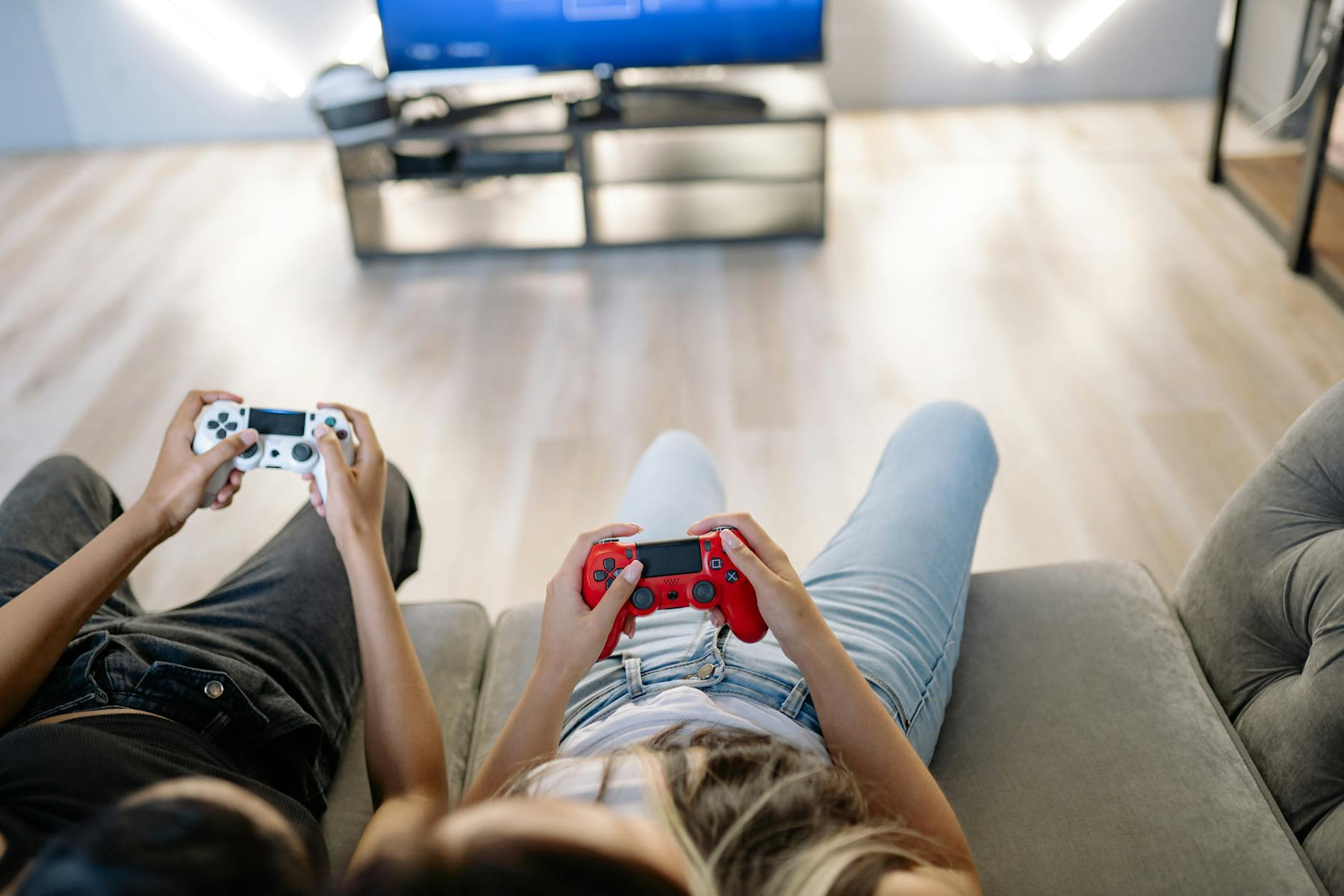 Two friends playing video games together indoors with game controllers. on The Loading Screen