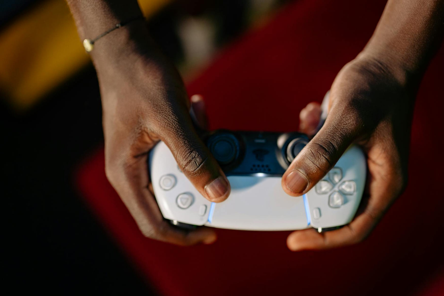 Close-up view of hands gripping a wireless gaming controller. on The Loading Screen