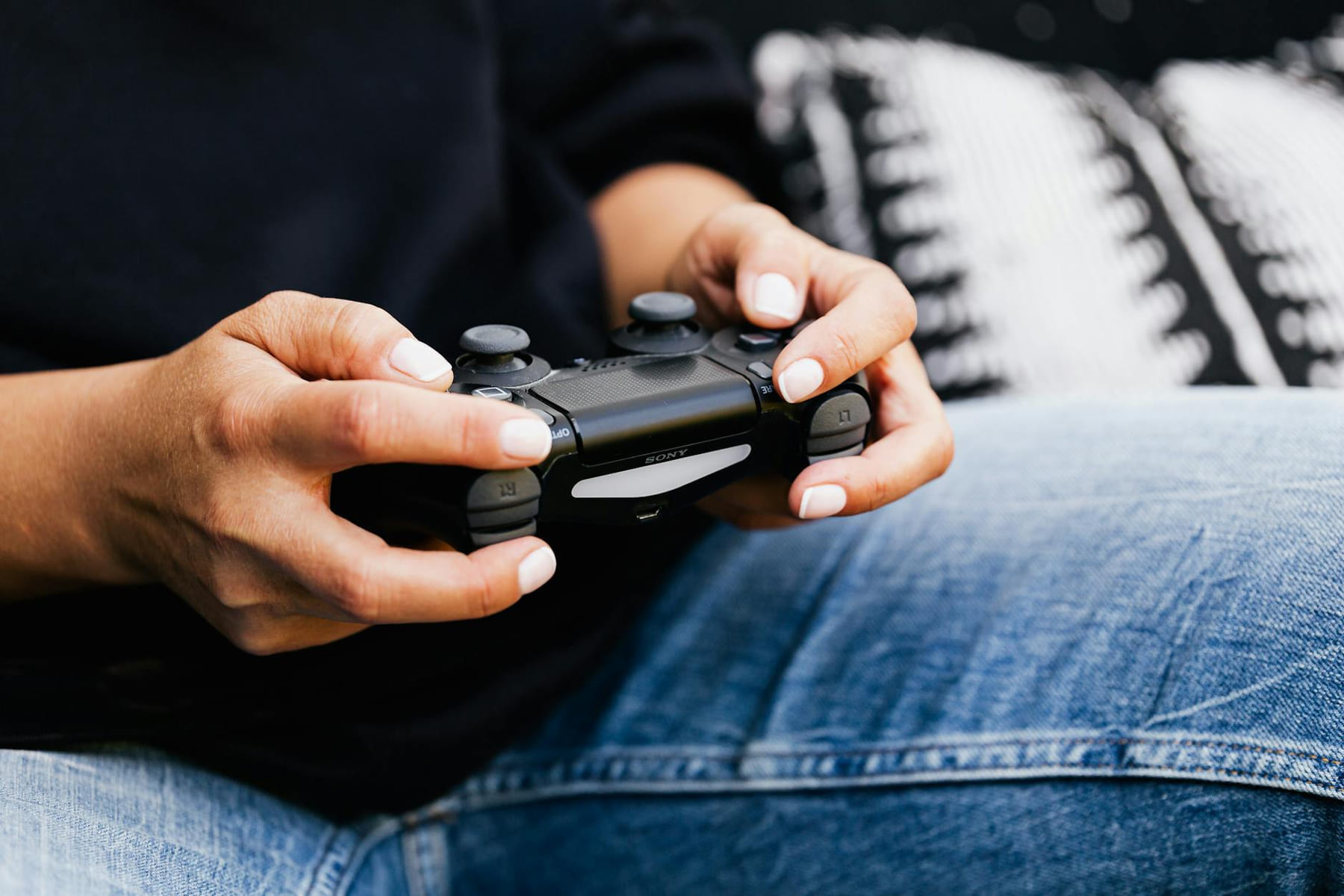 A person playing video games with a close-up of their hands holding a gaming controller. on The Loading Screen