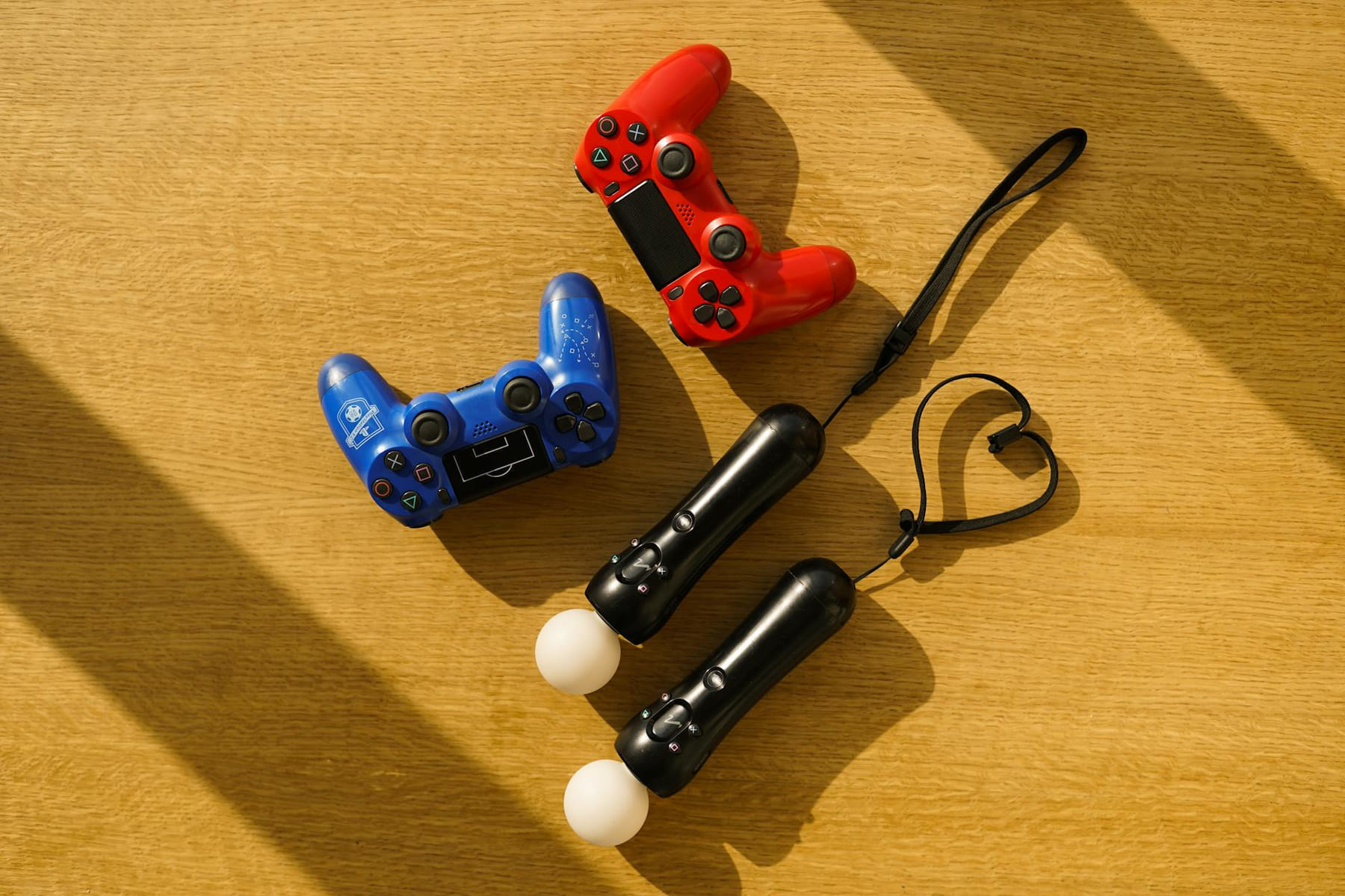 High angle view of gaming controllers on a sunlight-illuminated wooden table. on The Loading Screen