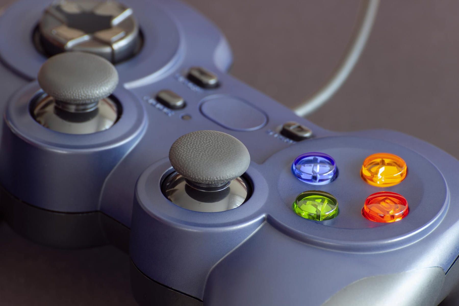 Detailed close-up of a gaming controller emphasizing its vibrant buttons. on The Loading Screen