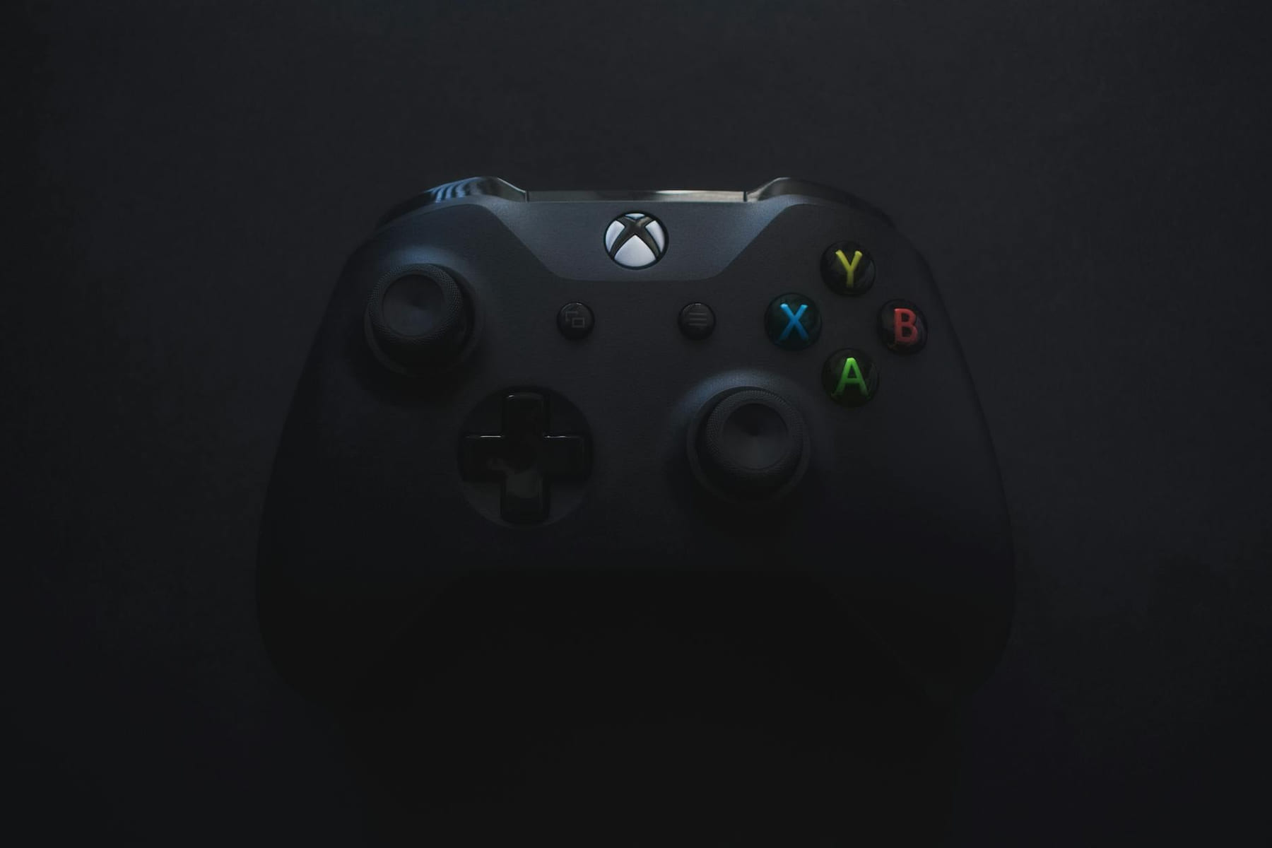 Xbox controller illuminated against a dark background, perfect for gaming themes. on The Loading Screen