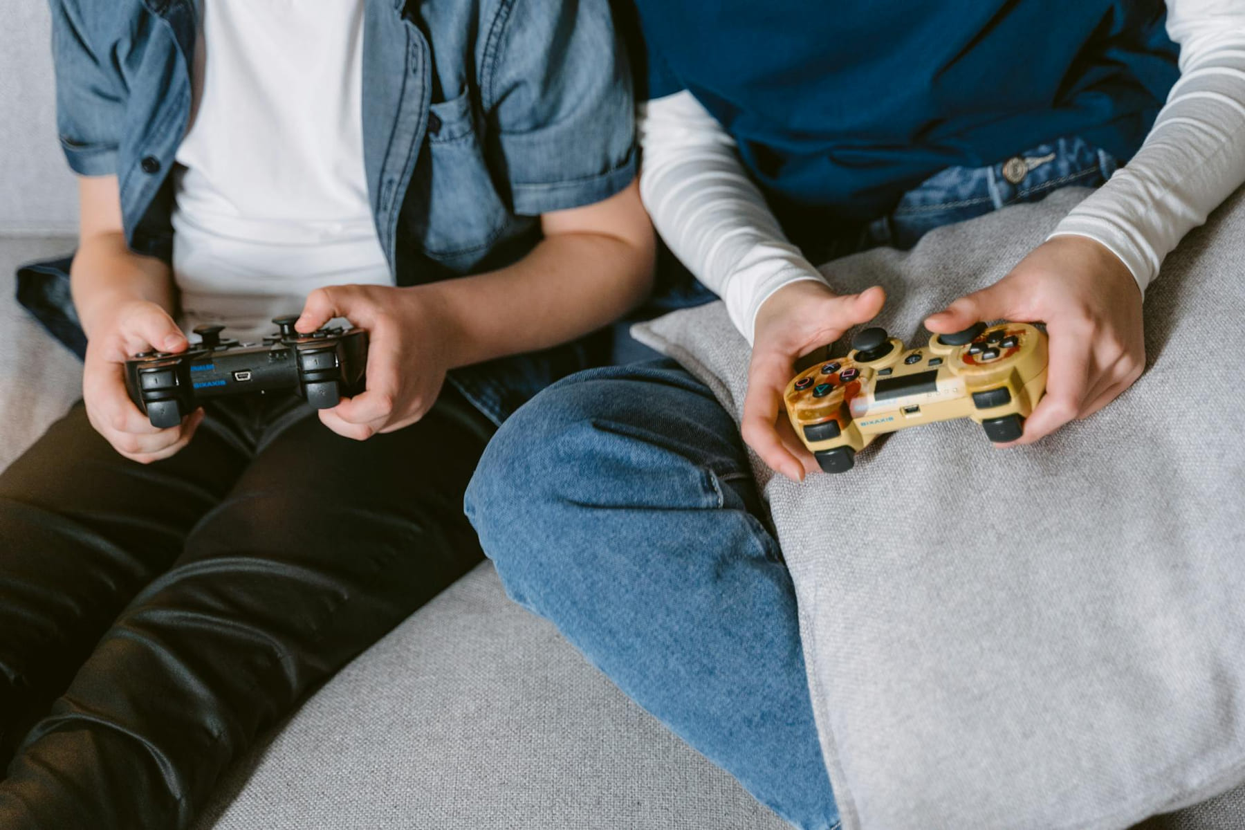 Two teenagers absorbed in console gaming indoors, focused on controllers. on The Loading Screen